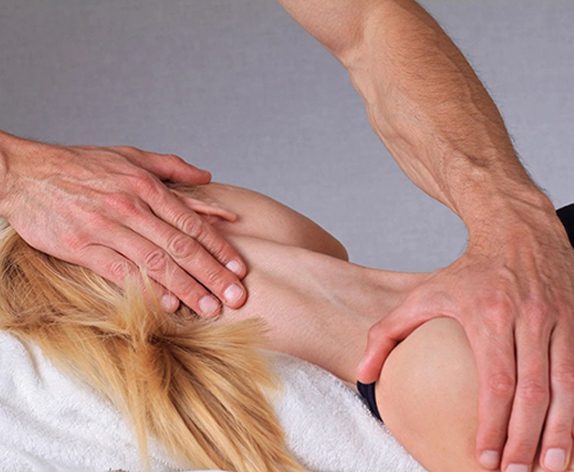 A person is getting their back examined by an osteopath.